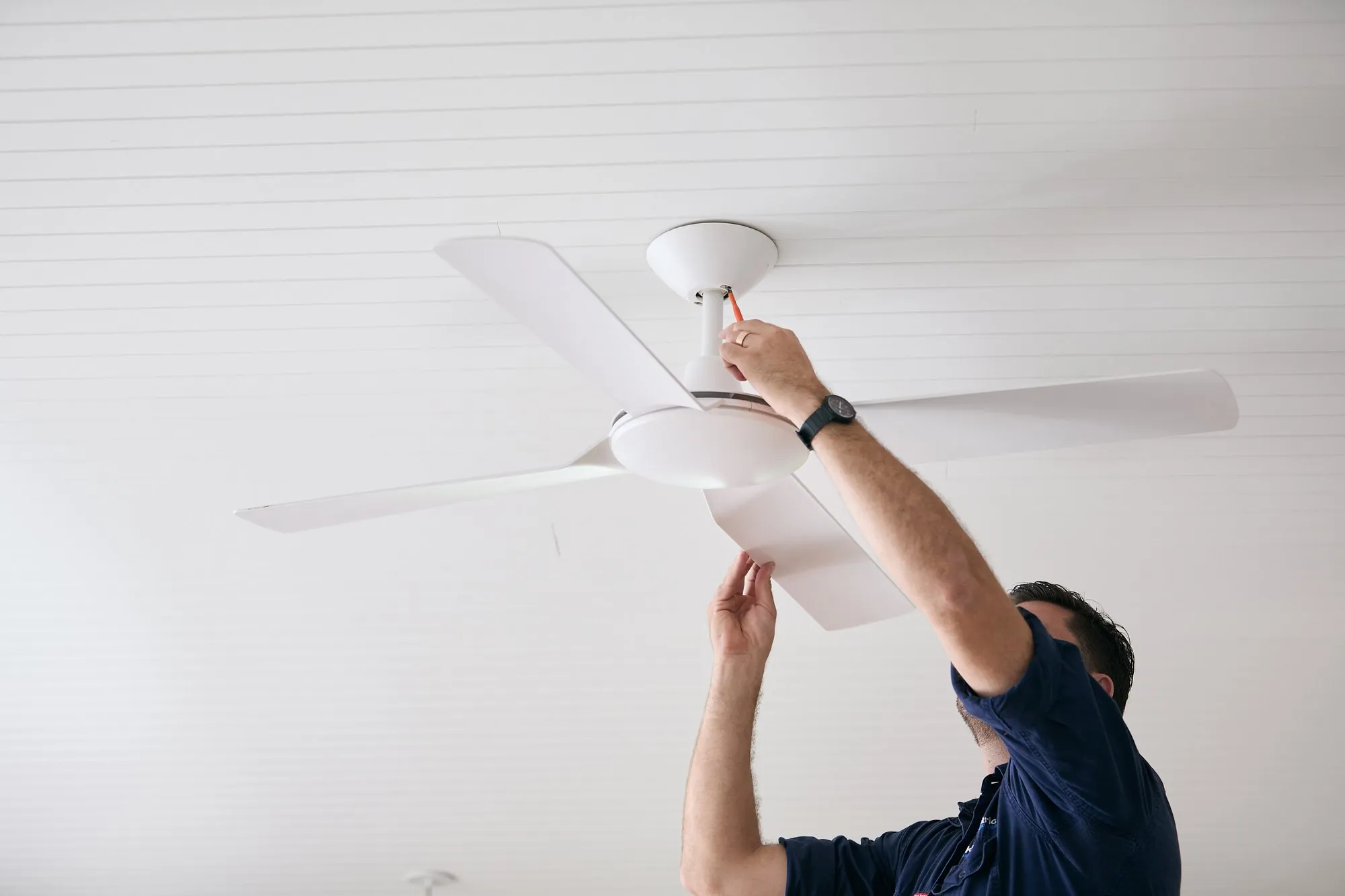 Anthony Kitson wiring a ceiling fan