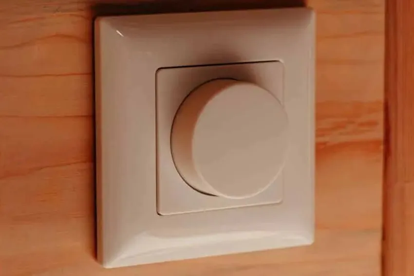 A dimmer on a timber wall