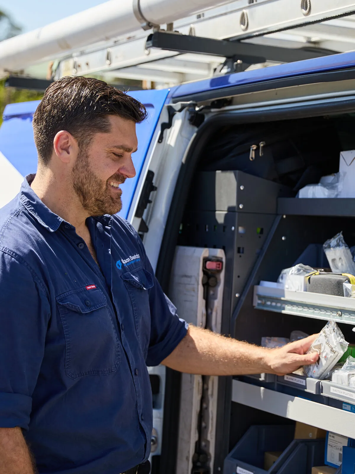 Kitson electrician picking supplies from the van