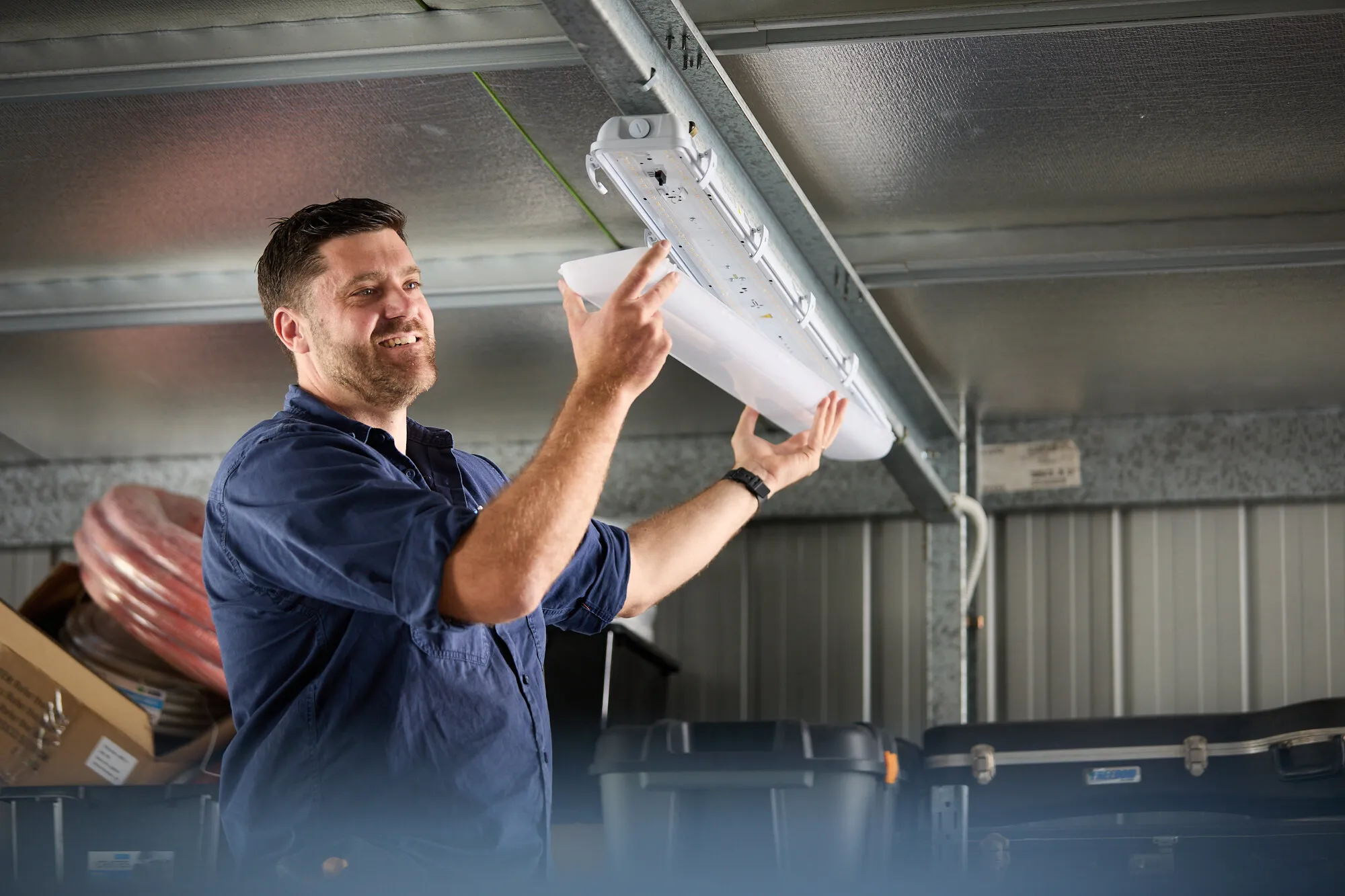 Anthony Kitson installing an LED batten light