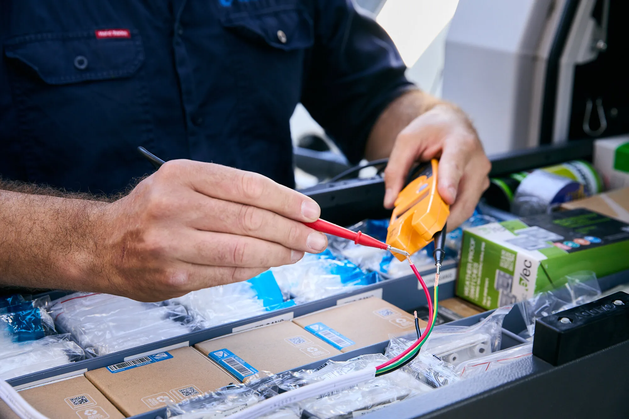 Anthony Kitson testing wiring with a multimeter
