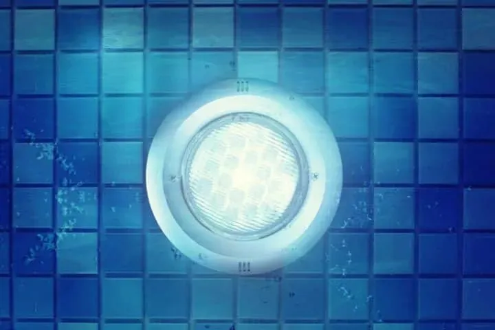 A pool light glowing under water