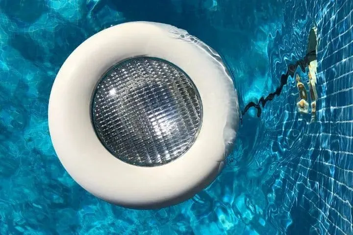 A pool light in tiled wall