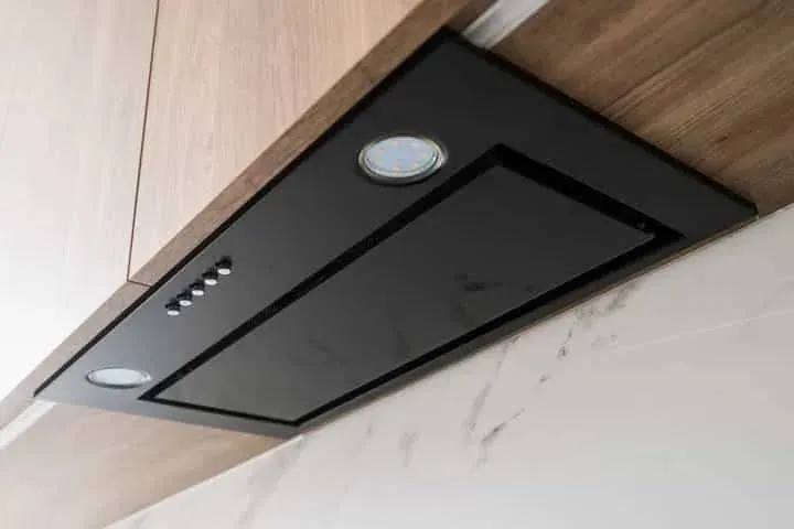 A rangehood in a white kitchen