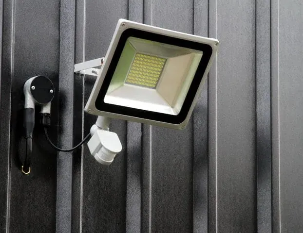 A security flood light on a wall