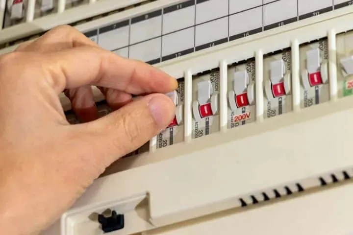 Switching off a labelled circuit breaker at the switchboard before electrical work